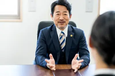クライアントに説明する男性弁護士。離婚と子どもとの断絶に直面した親が弁護士に相談する。